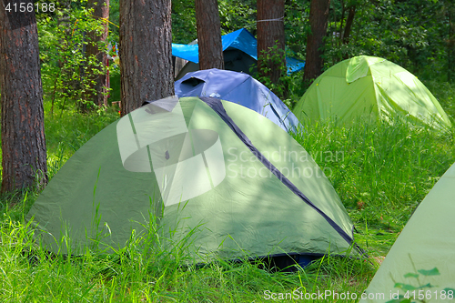 Image of camping outdoor with tent in woods in summer