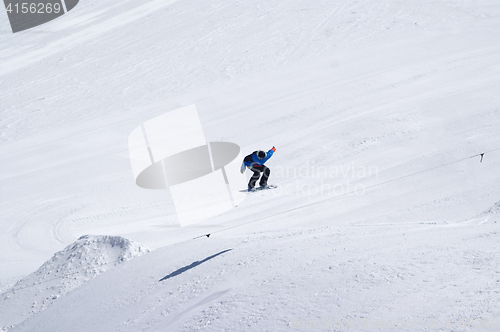 Image of Snowboarder jumping in terrain park at ski resort on sun winter 