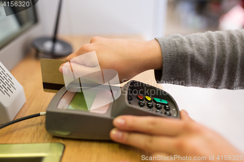 Image of close up of hand inserting bank card to terminal