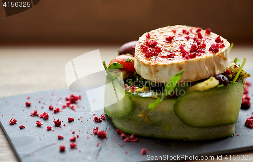 Image of goat cheese salad with vegetables at restaurant