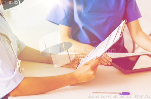 Image of close up of doctor with medical report at hospital