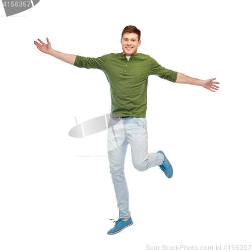 Image of smiling young man jumping in air