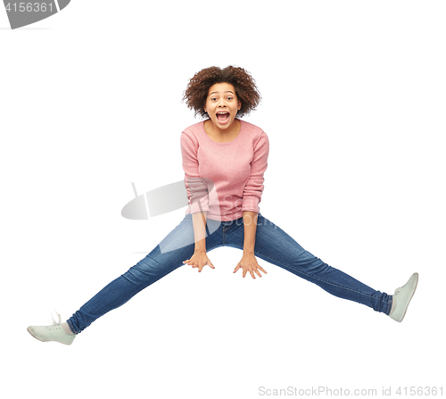 Image of happy african american woman jumping over white