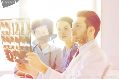 Image of group of doctors looking to x-ray at hospital