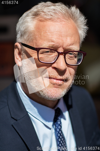 Image of close up of senior businessman in eyeglasses