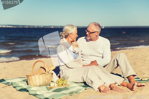 Image of happy senior couple talking on summer beach