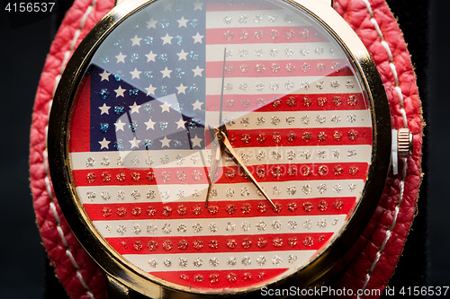 Image of clock on a black background. American Flag