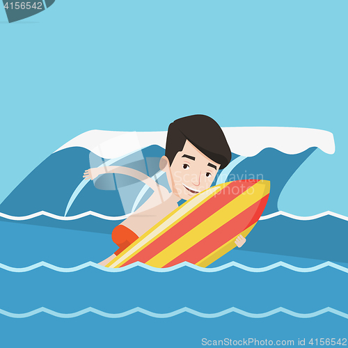 Image of Happy surfer in action on a surf board.