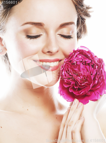 Image of young beauty woman with flower peony pink closeup makeup soft te
