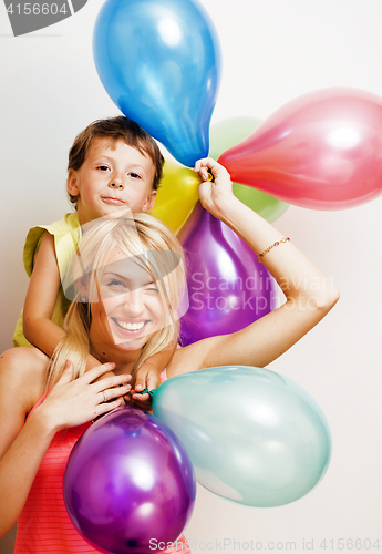 Image of pretty family with color balloons on white background, blond woman with little boy at birthday