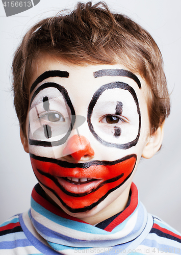 Image of little cute boy with facepaint like clown, pantomimic expression