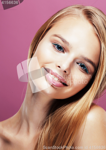 Image of young pretty blonde woman with hairstyle close up and makeup on pink background