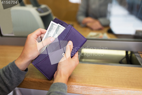 Image of hands with money at bank or currency exchanger