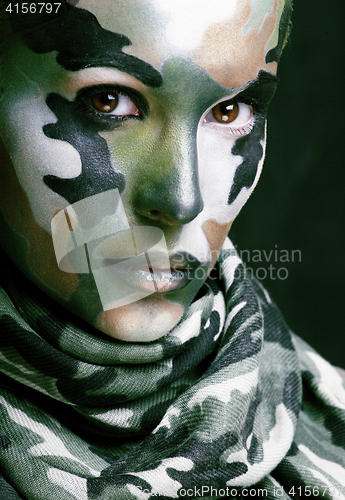 Image of Beautiful young fashion woman with military style clothing and face paint make-up, khaki colored