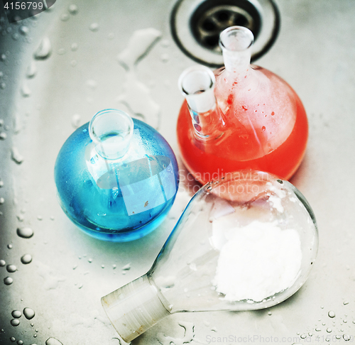 Image of waste products in laboratory, medicine-glass with colored red and blue liquid