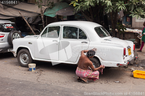 Image of Man washing car