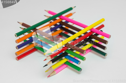 Image of Well of pencils on a light gray background