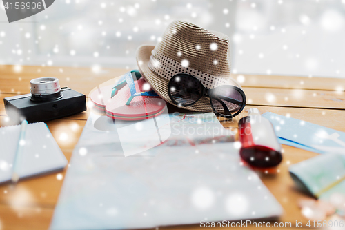 Image of travel map, hat, camera with flip-flops and shades