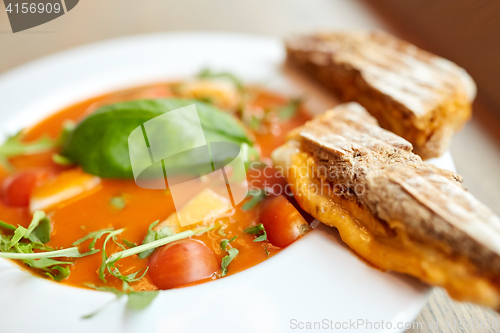 Image of close up of gazpacho soup with bread at restaurant