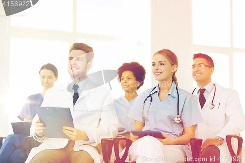 Image of group of happy doctors on seminar at hospital