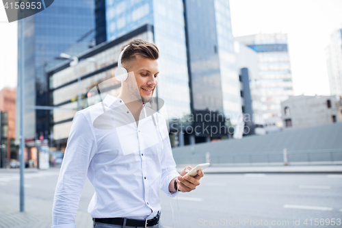 Image of man with headphones and smartphone listening music