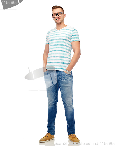 Image of smiling young man in eyeglasses over white