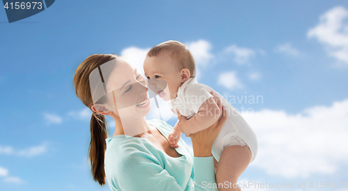 Image of happy young mother with little baby over blue sky