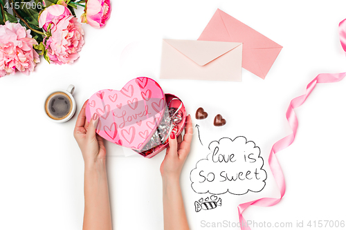 Image of The female hands with gift box on white background