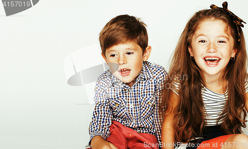 Image of little cute boy and girl hugging playing on white background, ha