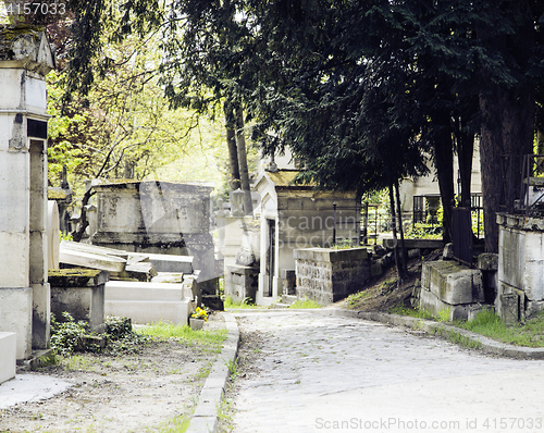 Image of Tombstones in cemetery at dusk, gothic style crosses summer