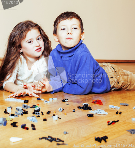 Image of funny cute children playing lego at home, boys and girl smiling, first education role lifestyle