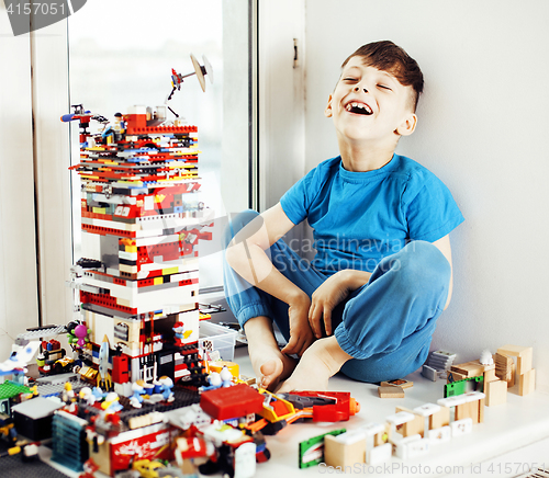 Image of little cute preschooler boy playing toys at home happy smiling, 