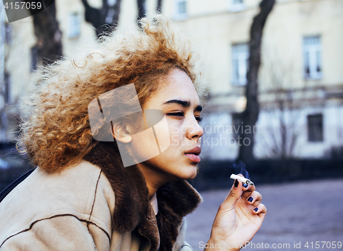 Image of young pretty girl teenage outside smoking cigarette close up, lo