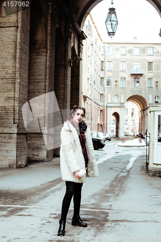 Image of young pretty stylish teenage girl outside on city street fancy f