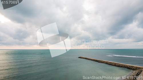 Image of Pier stretching into the sea on a background seascape