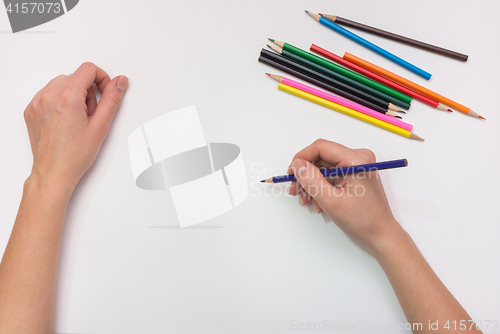 Image of Female hand painted with colored pencils on paper, close-up