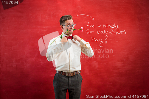 Image of Man holding bouquet on red