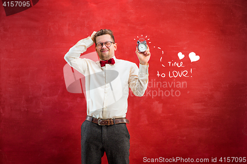 Image of Young funny man with abstract clock