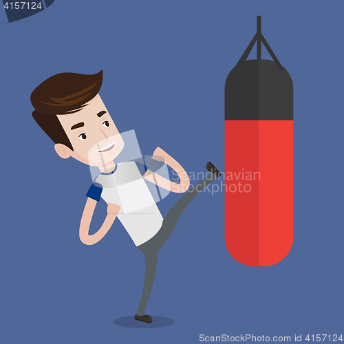 Image of Man exercising with punching bag.