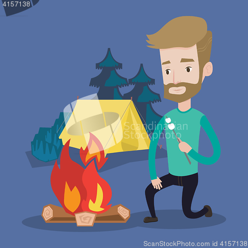 Image of Businessman roasting marshmallow over campfire.