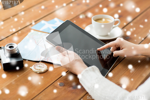 Image of close up of traveler hands with tablet pc and map