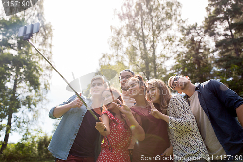 Image of friends taking selfie at party in summer garden