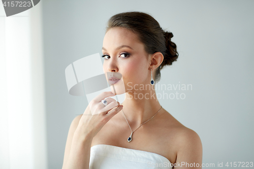 Image of beautiful woman with earring, ring and pendant