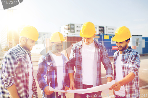 Image of group of builders with tablet pc and blueprint