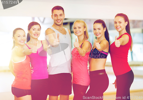 Image of group of people in the gym showing thumbs up