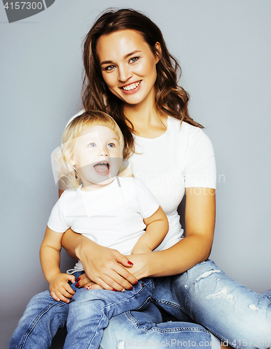 Image of mother with daughter together in bed smiling, happy family close