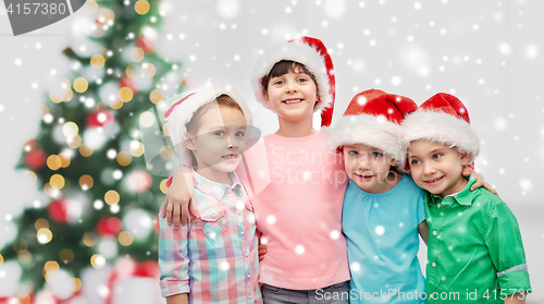 Image of happy little children in christmas santa hats