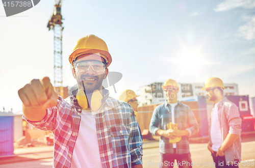 Image of builders pointing finger at you on construction