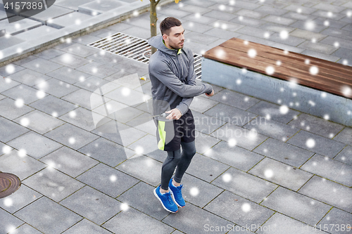 Image of man exercising with jump-rope outdoors