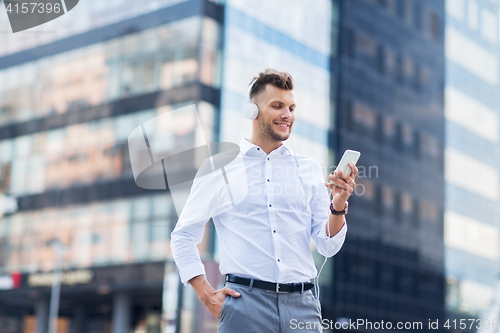 Image of man with headphones and smartphone listening music